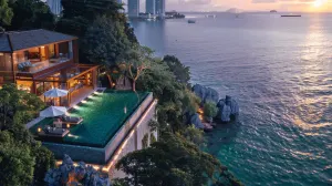 Cliffside villa with infinity pool at dusk