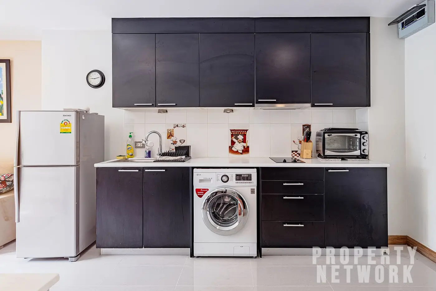 Spacious 2-bedroom, 2-bathroom condo at D 65 Condominium, 67.8 sqm, fully furnished with a balcony, modern kitchen, and amenities near BTS Ekkamai.