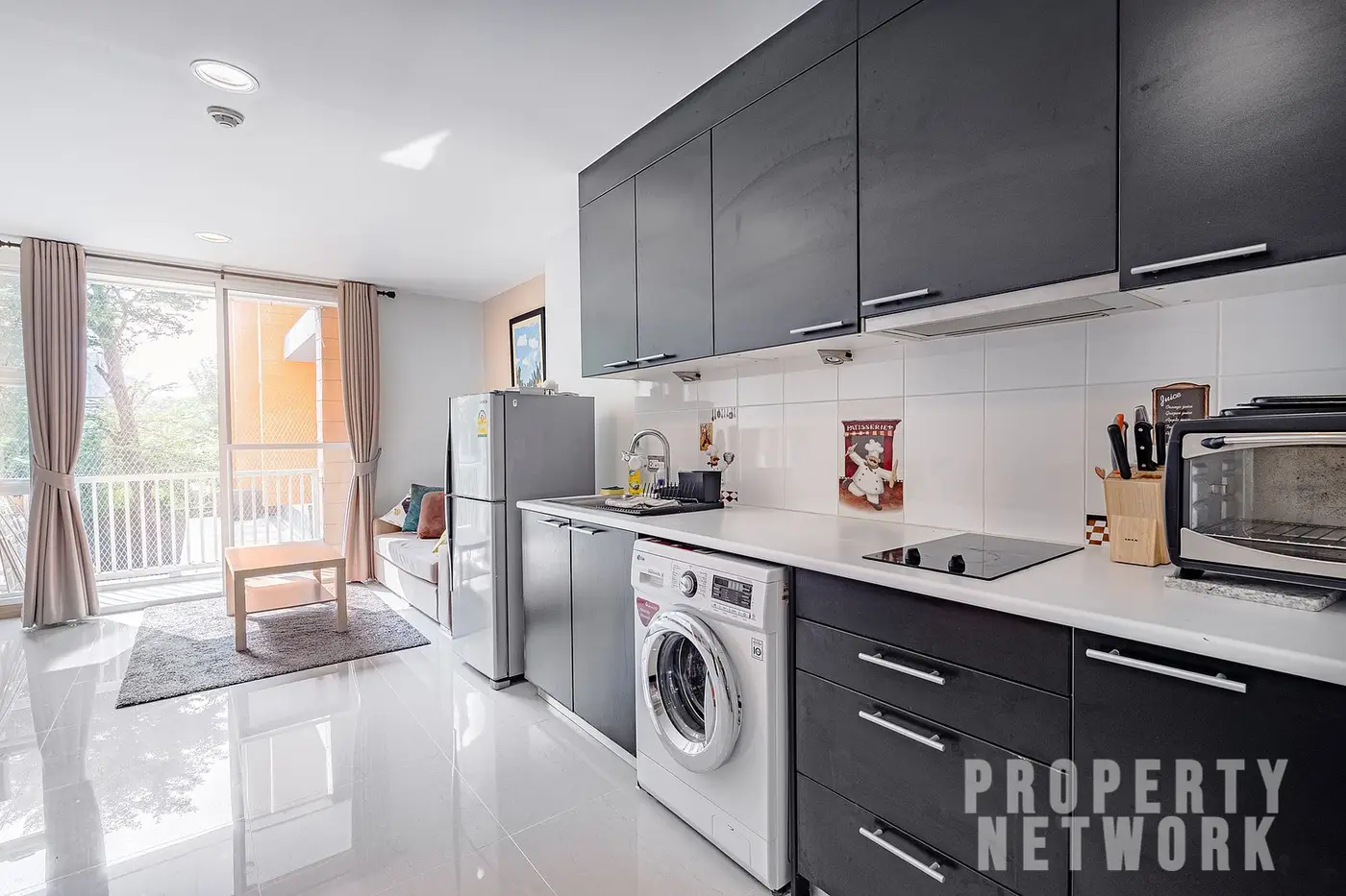 Spacious 2-bedroom, 2-bathroom condo at D 65 Condominium, 67.8 sqm, fully furnished with a balcony, modern kitchen, and amenities near BTS Ekkamai.