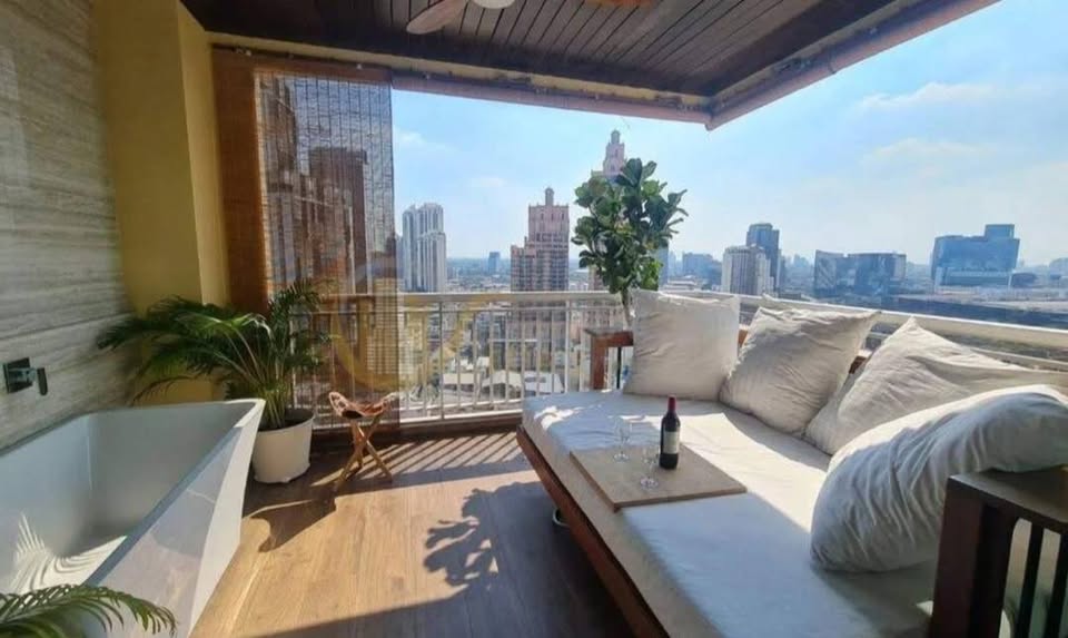 Spacious 4-bedroom penthouse at Wilshire Condominium, featuring modern interiors, skyline views, private balcony, and high-end amenities in Sukhumvit 22, Bangkok.