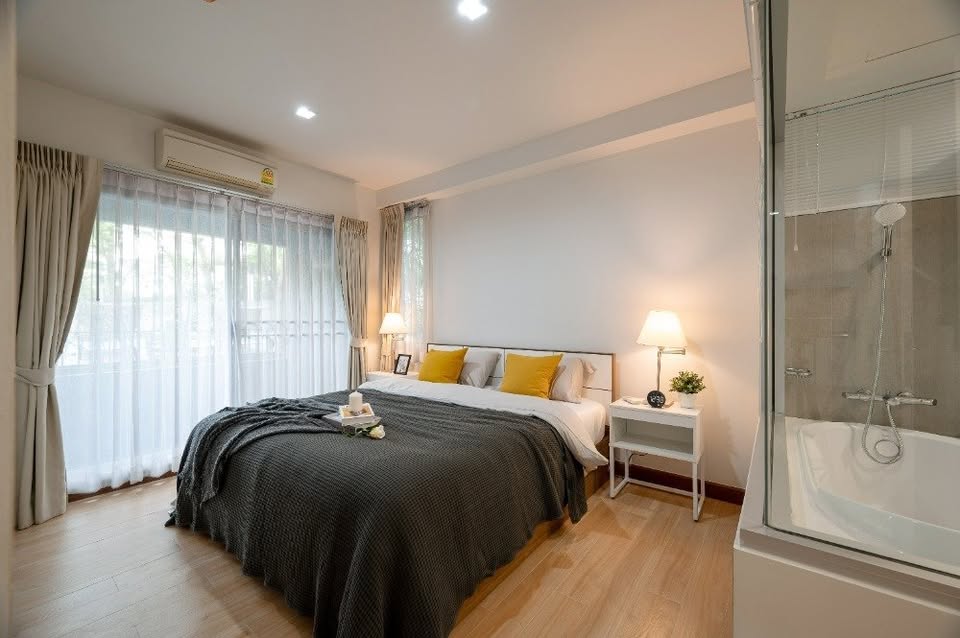 Modern 2-bedroom condo at The Seed Muse 26 with private garden, stylish interiors, and direct pool access in Sukhumvit 26, Bangkok.