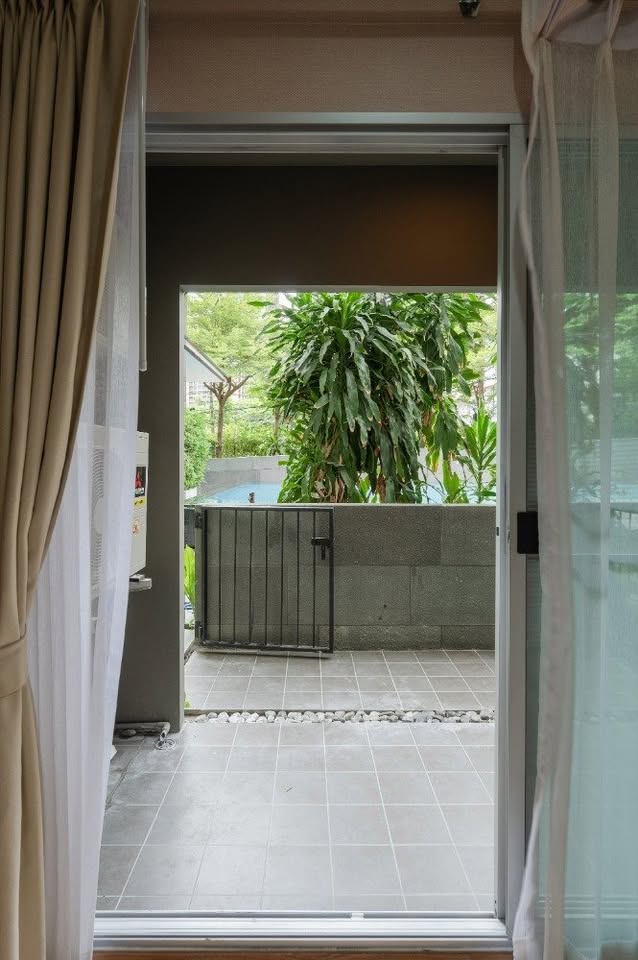Modern 2-bedroom condo at The Seed Muse 26 with private garden, stylish interiors, and direct pool access in Sukhumvit 26, Bangkok.