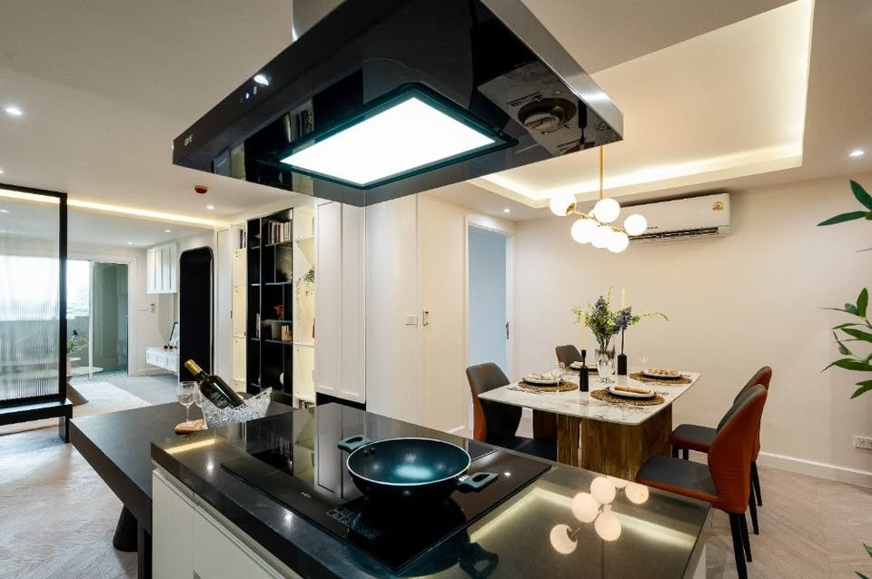 Top-floor corner unit at Le Nice Ekamai featuring a spacious 3-bedroom layout, modern western kitchen with island, and panoramic city views.