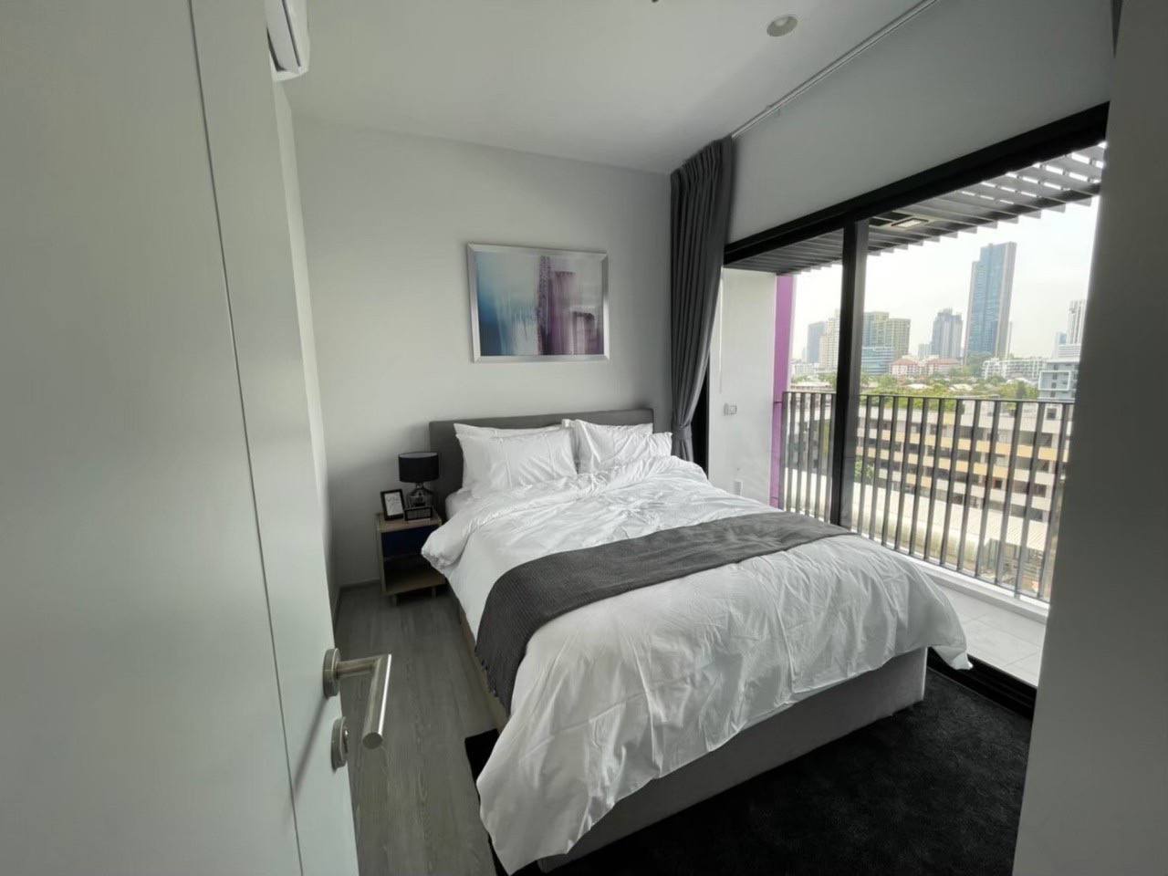 Modern 1-bedroom condo at XT Ekkamai, fully furnished with smart home features, city views, and premium amenities, including a rooftop pool and co-working spaces.