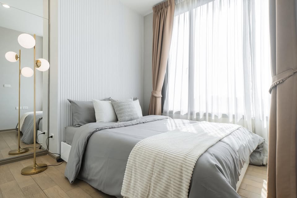 Elegant 2-bedroom condo at Pyne by Sansiri, featuring stylish furnishings, high-floor city views, and premium facilities, located next to BTS Ratchathewi.