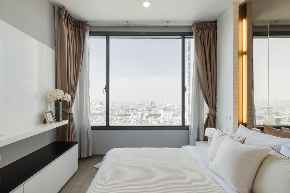 Elegant 2-bedroom condo at Pyne by Sansiri, featuring stylish furnishings, high-floor city views, and premium facilities, located next to BTS Ratchathewi.