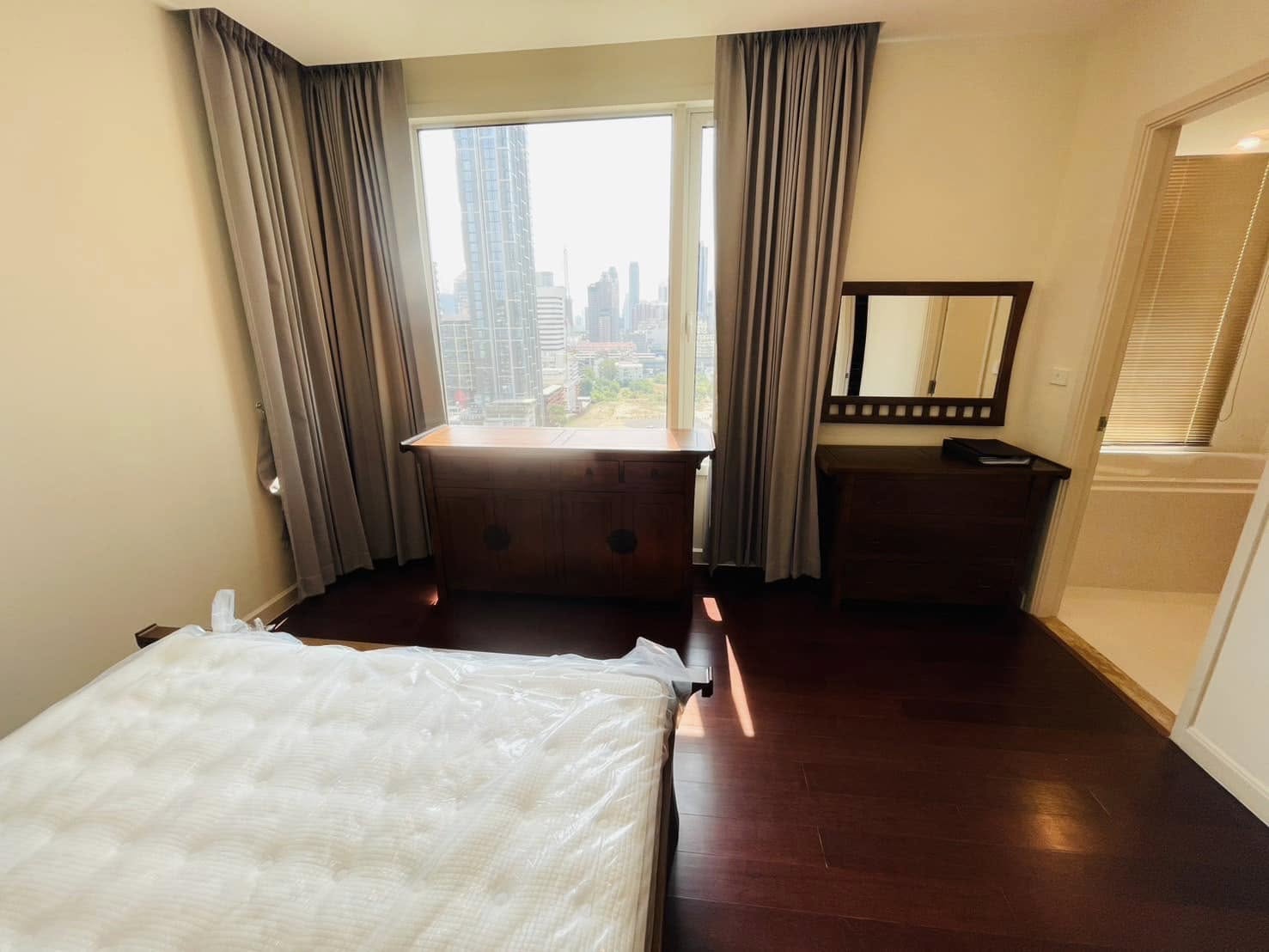 Elegant 2-bedroom condo at Manhattan Chidlom, featuring stylish furnishings, high-floor city views, and premium amenities, located near BTS Chidlom in central Bangkok.