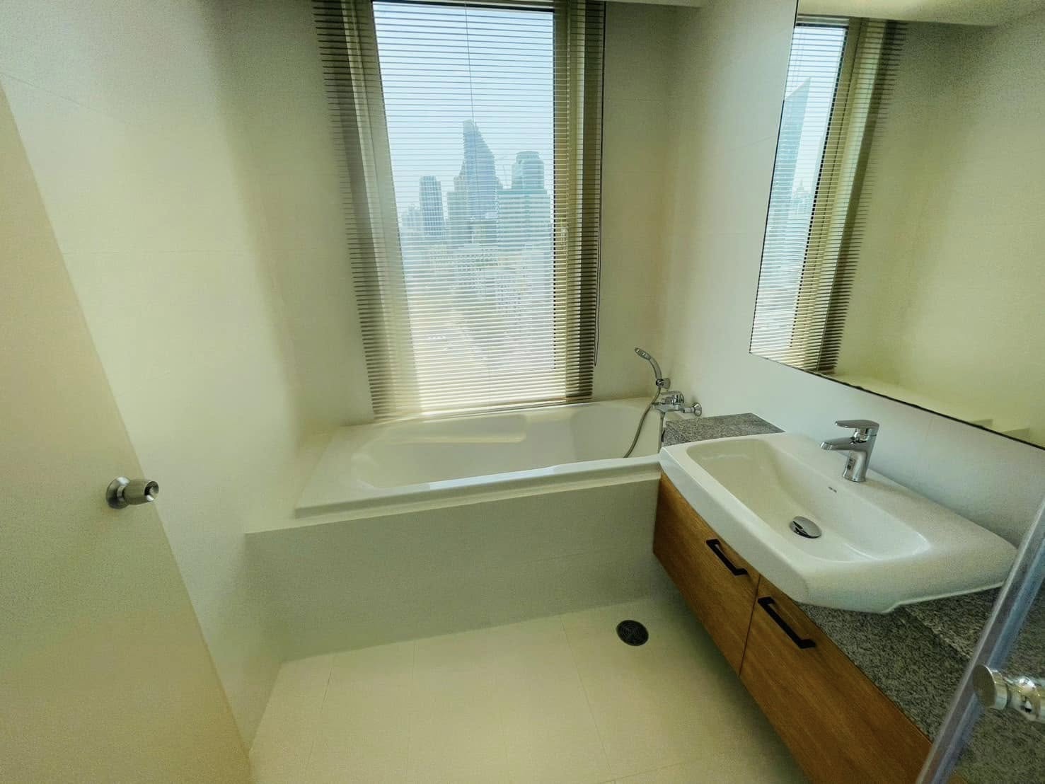 Elegant 2-bedroom condo at Manhattan Chidlom, featuring stylish furnishings, high-floor city views, and premium amenities, located near BTS Chidlom in central Bangkok.
