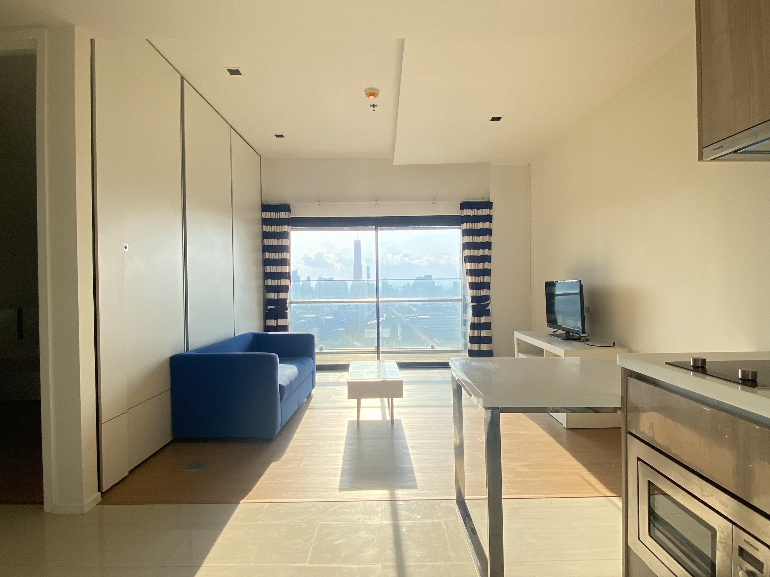 Elegant 1-bedroom condo at Circle Living Prototype with modern furnishings, high-floor city views, and eco-friendly smart home features in Bangkok.