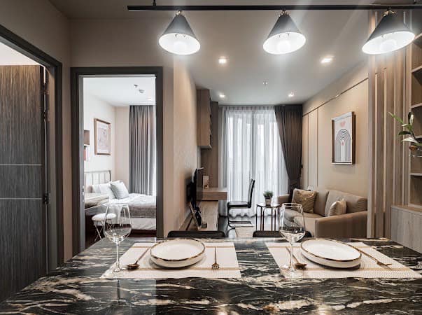 Luxurious 2-bedroom condo at Ideo Q Victory with modern interiors, floor-to-ceiling windows, and panoramic city views from the 31st floor in Bangkok.