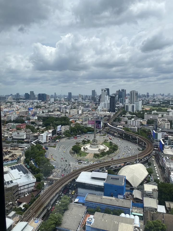 Luxurious 2-bedroom condo at Ideo Q Victory with modern interiors, floor-to-ceiling windows, and panoramic city views from the 31st floor in Bangkok.