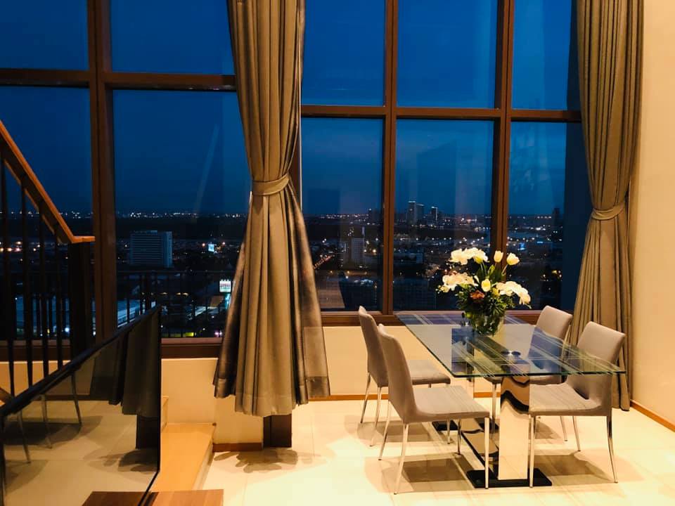 Spacious 1-bed, 2-bath duplex condo at The Emporio Place, 83 sqm, high floor with river view. Prime Sukhumvit 24 location near BTS Phrom Phong. Rent: 55,000 THB/month.