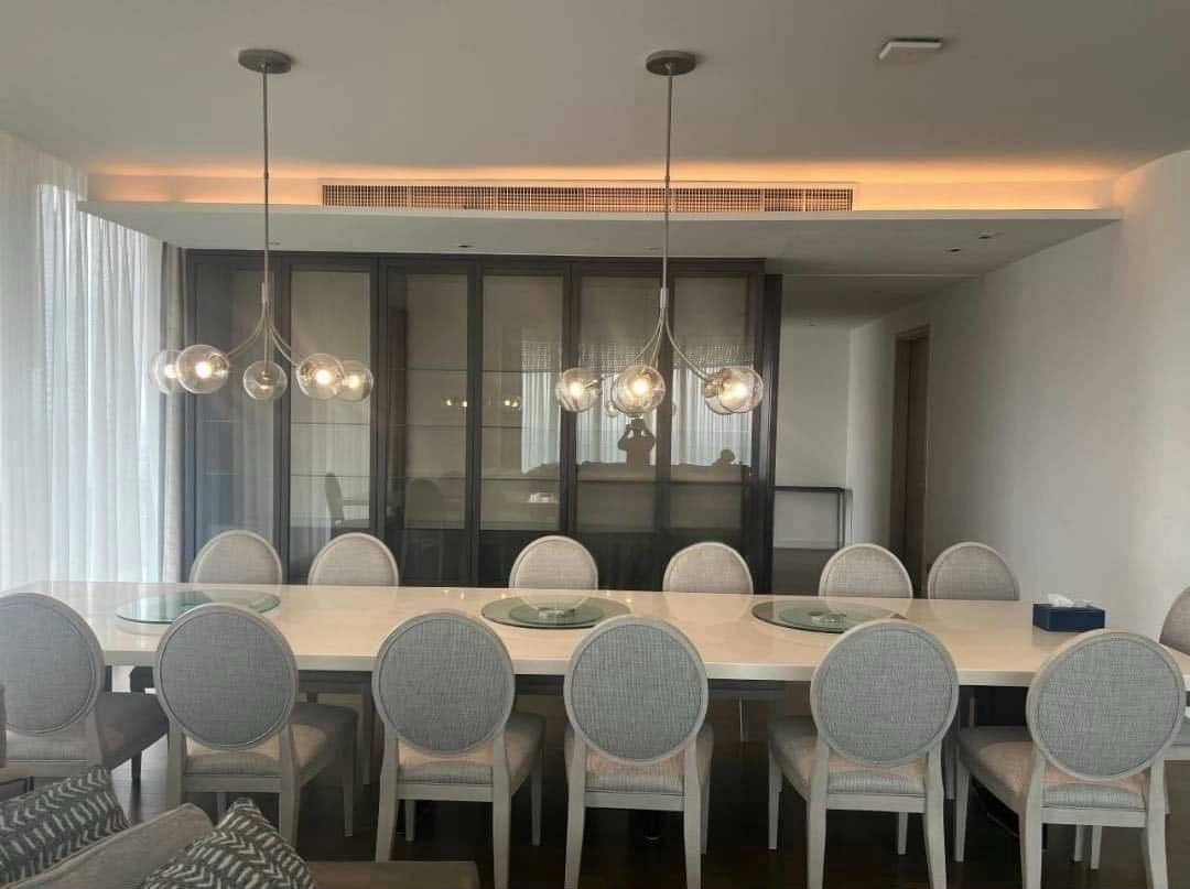 Spacious living room with floor-to-ceiling windows and panoramic city views in a luxury 4-bedroom condo at Magnolias Ratchadamri Boulevard, Bangkok.
