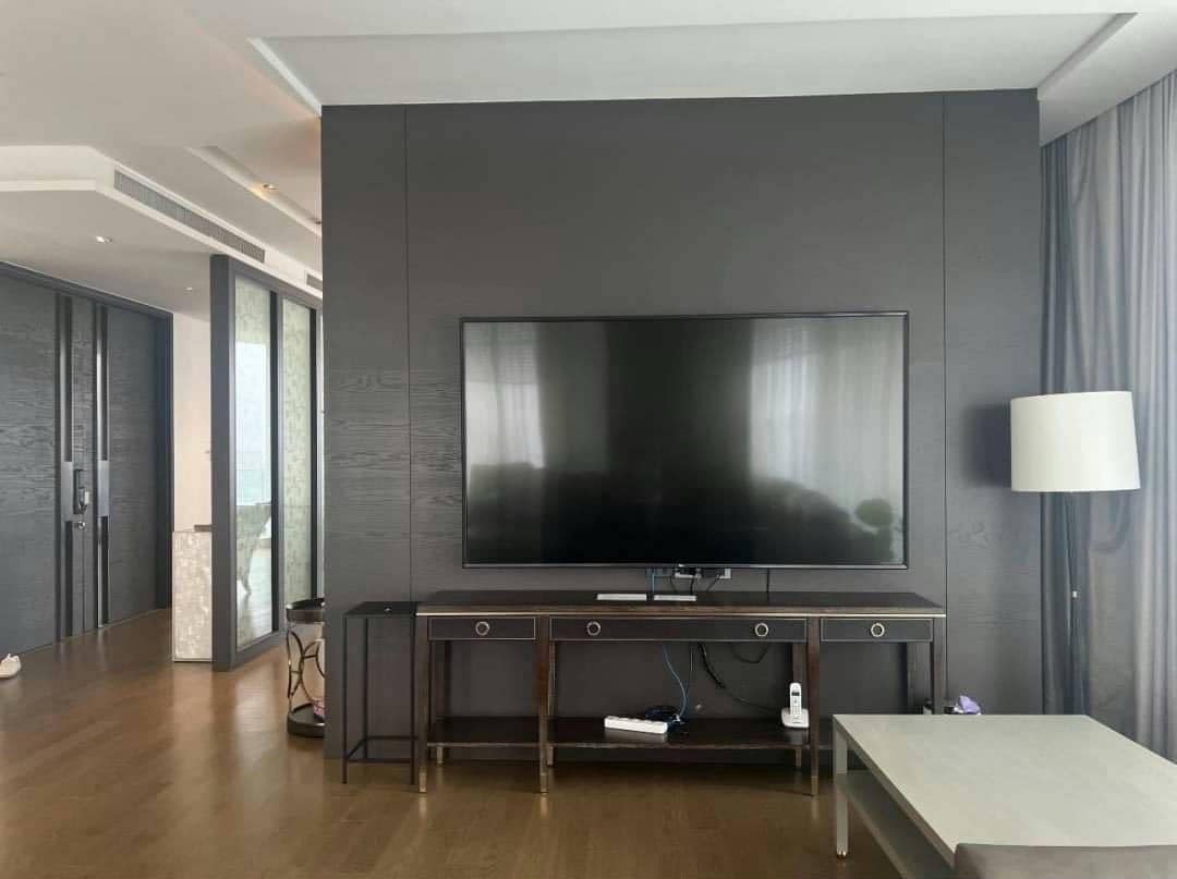 Spacious living room with floor-to-ceiling windows and panoramic city views in a luxury 4-bedroom condo at Magnolias Ratchadamri Boulevard, Bangkok.