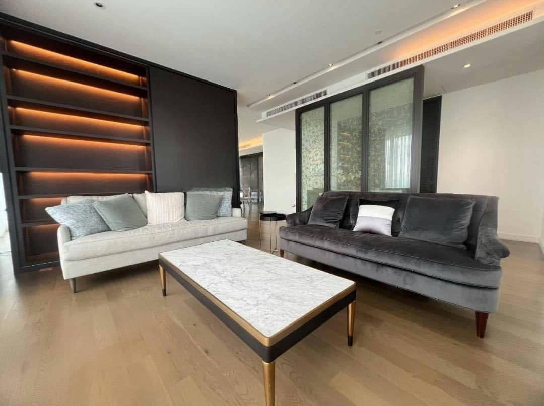 Spacious living room with floor-to-ceiling windows and panoramic city views in a luxury 4-bedroom condo at Magnolias Ratchadamri Boulevard, Bangkok.