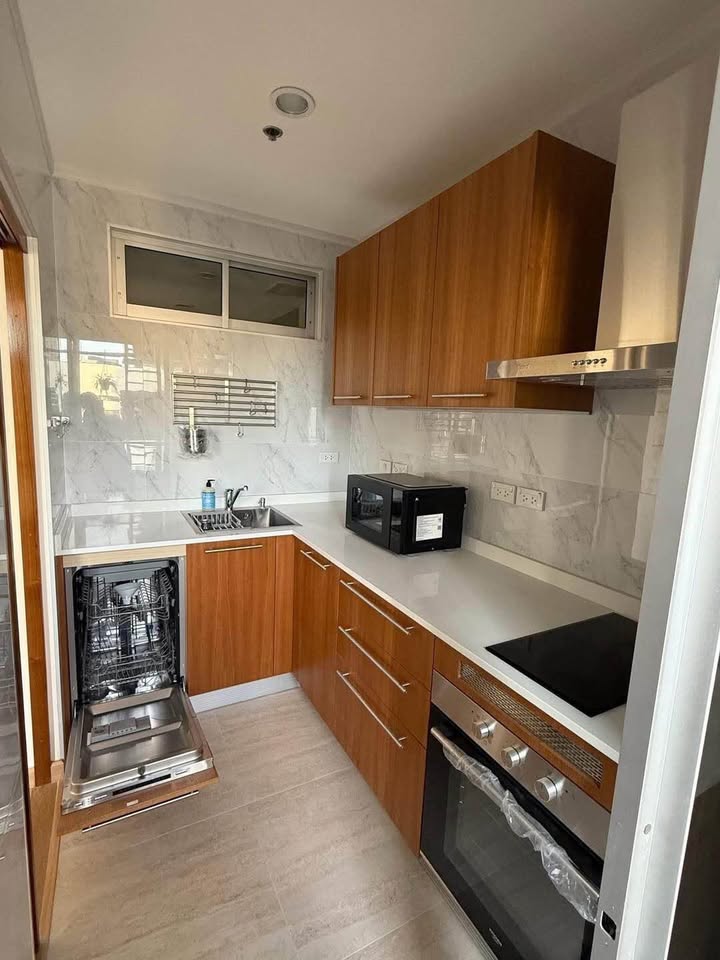 Bright living room of renovated 2-bedroom condo at Condo One X Sukhumvit 26 with city view and modern furnishings