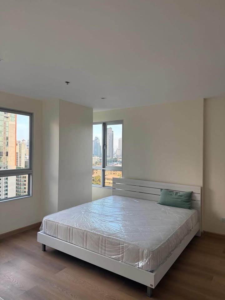 Bright living room of renovated 2-bedroom condo at Condo One X Sukhumvit 26 with city view and modern furnishings