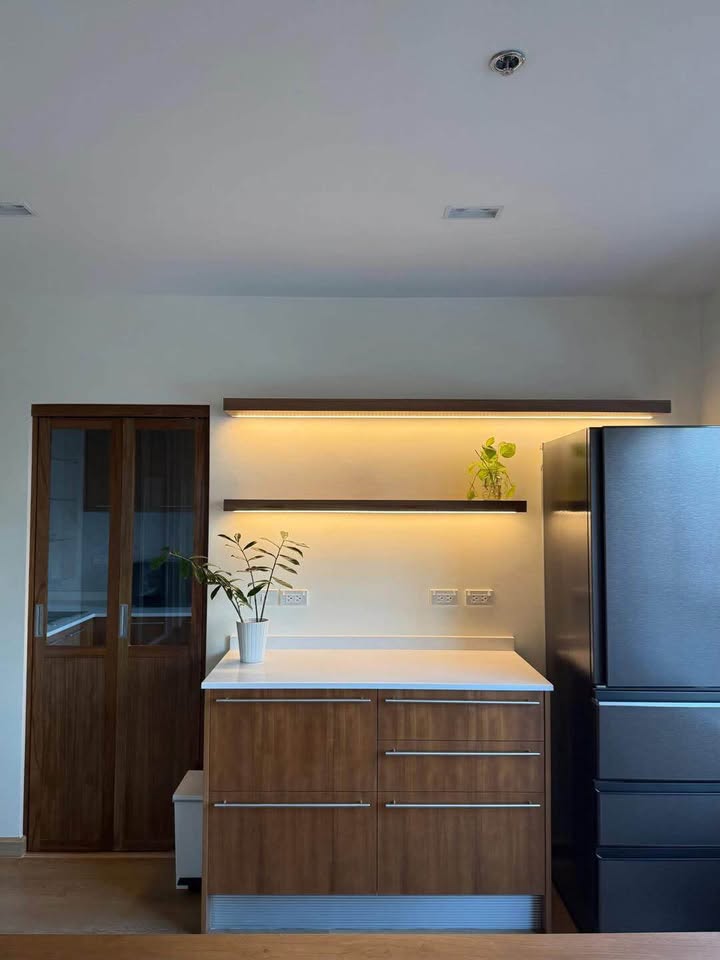 Bright living room of renovated 2-bedroom condo at Condo One X Sukhumvit 26 with city view and modern furnishings