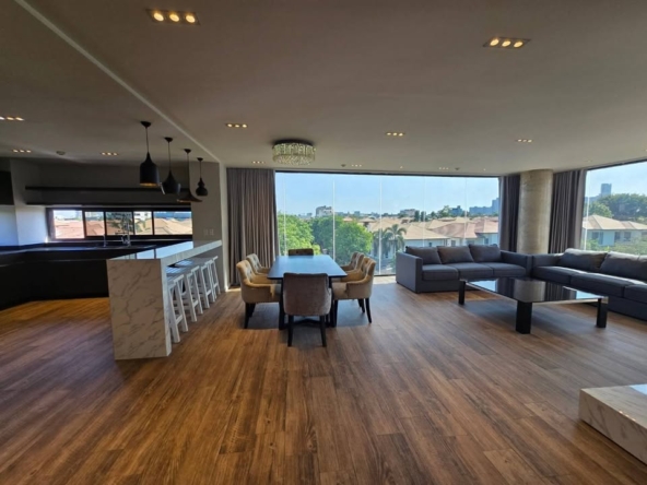 Luxurious 3-bed 3-bath 195 sqm penthouse near BTS Ekkamai. Fully furnished, private balconies, and parking. Rent for 110K THB/month.