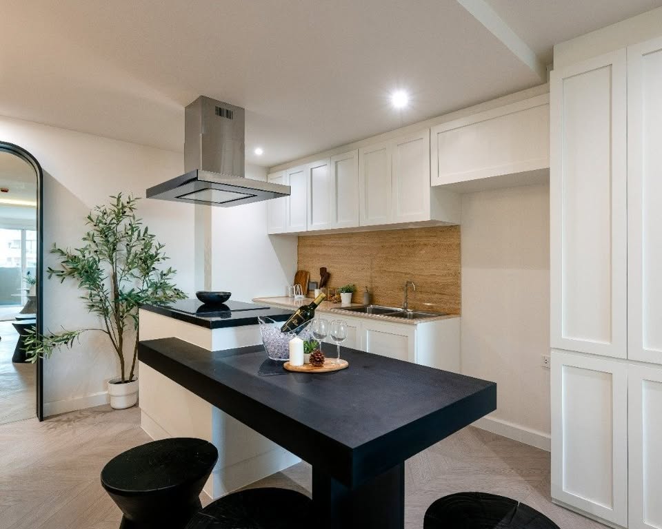 Top-floor corner unit at Le Nice Ekamai featuring a spacious 3-bedroom layout, modern western kitchen with island, and panoramic city views.