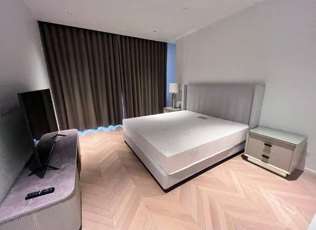 Spacious and modern living room in a 2-bedroom condo at Four Seasons Private Residences, featuring floor-to-ceiling windows and breathtaking views of the Chao Phraya River.