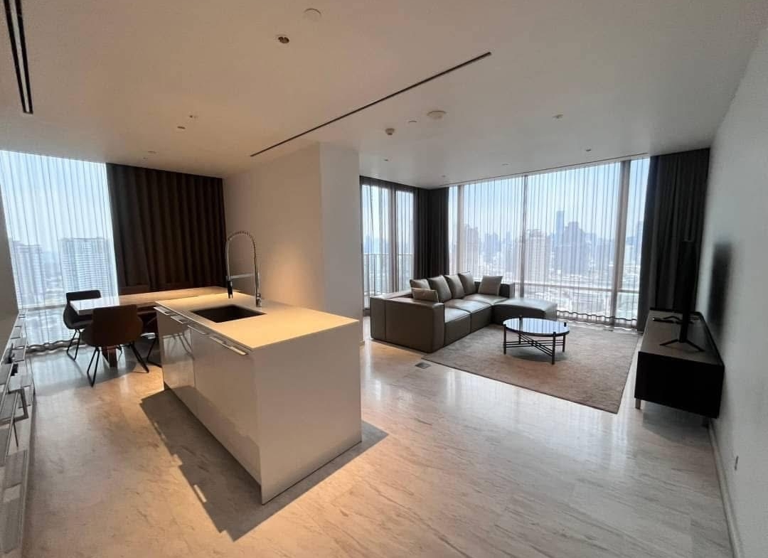 Spacious and modern living room in a 2-bedroom condo at Four Seasons Private Residences, featuring floor-to-ceiling windows and breathtaking views of the Chao Phraya River.
