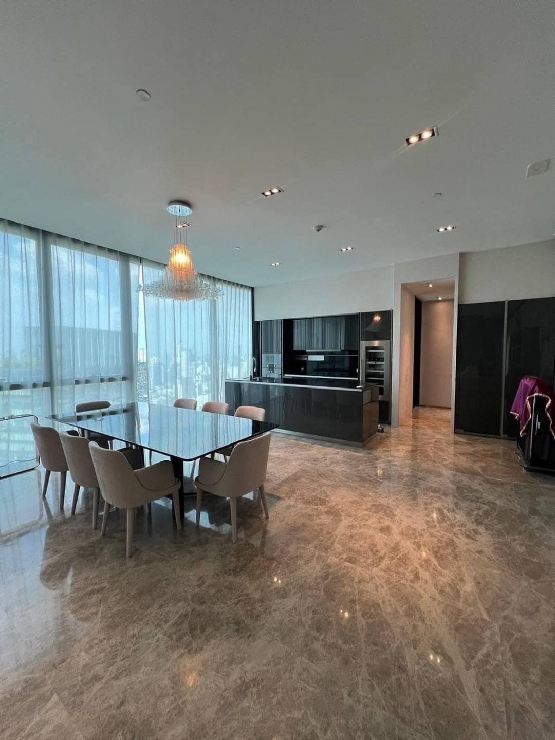 Spacious living room with floor-to-ceiling windows and panoramic city views in a luxury 3-bedroom condo at Marque Sukhumvit 39, Bangkok.