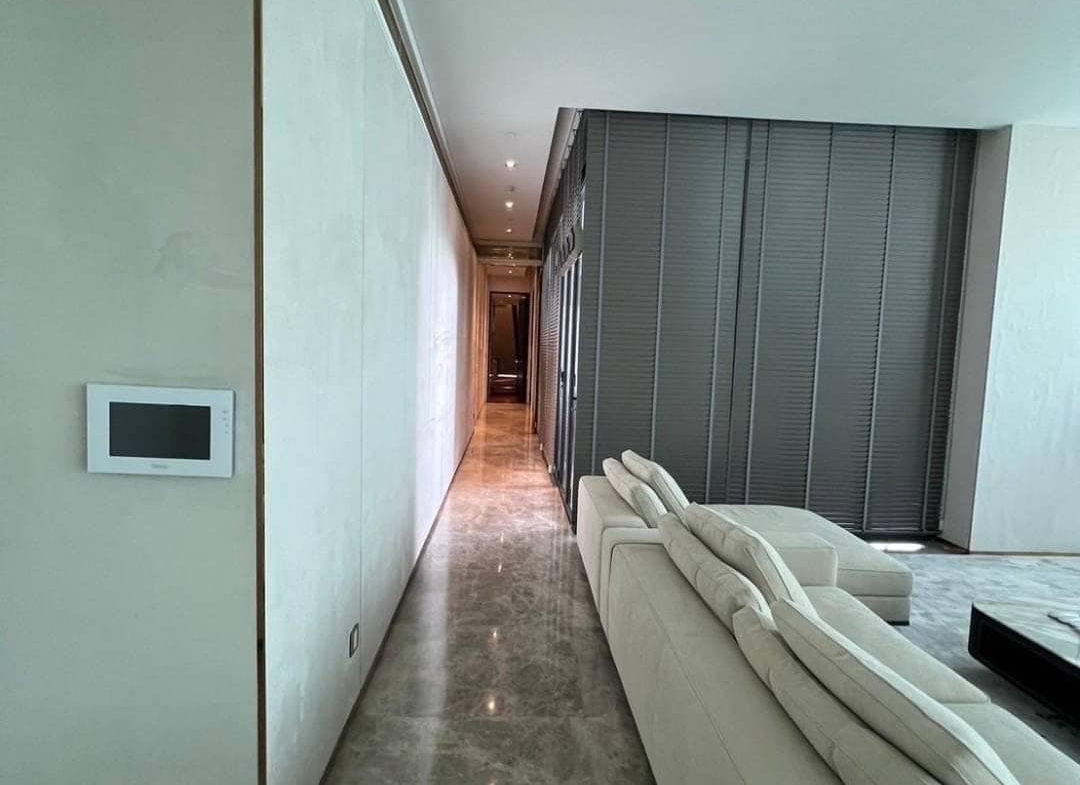 Spacious living room with floor-to-ceiling windows and panoramic city views in a luxury 3-bedroom condo at Marque Sukhumvit 39, Bangkok.