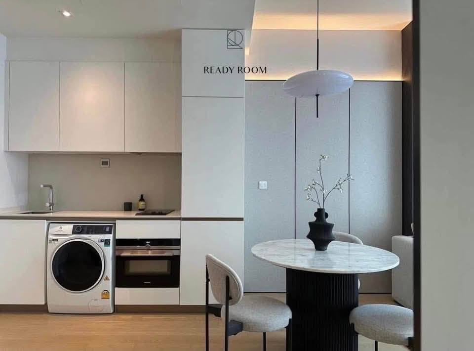 Spacious and modern living room in a 1-bedroom condo at The Strand Thonglor, featuring floor-to-ceiling windows and elegant furniture near BTS Thonglor, Bangkok.