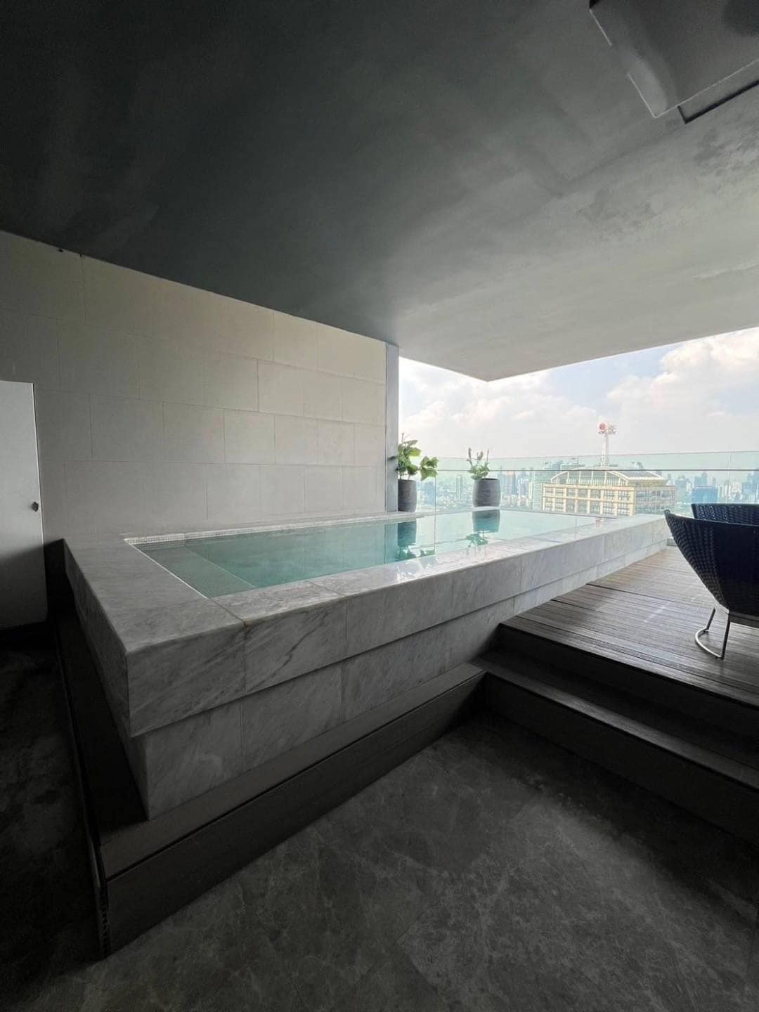 Spacious living room with floor-to-ceiling windows and panoramic city views in a luxury 3-bedroom condo at Marque Sukhumvit 39, Bangkok.