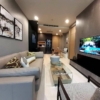 Elegant living room of 2-bedroom condo at Noble Ploenchit with city view and modern furnishings