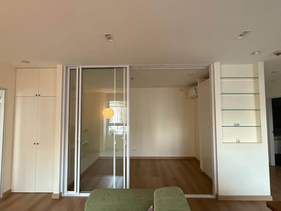 Bright living room of renovated 2-bedroom condo at Condo One X Sukhumvit 26 with city view and modern furnishings