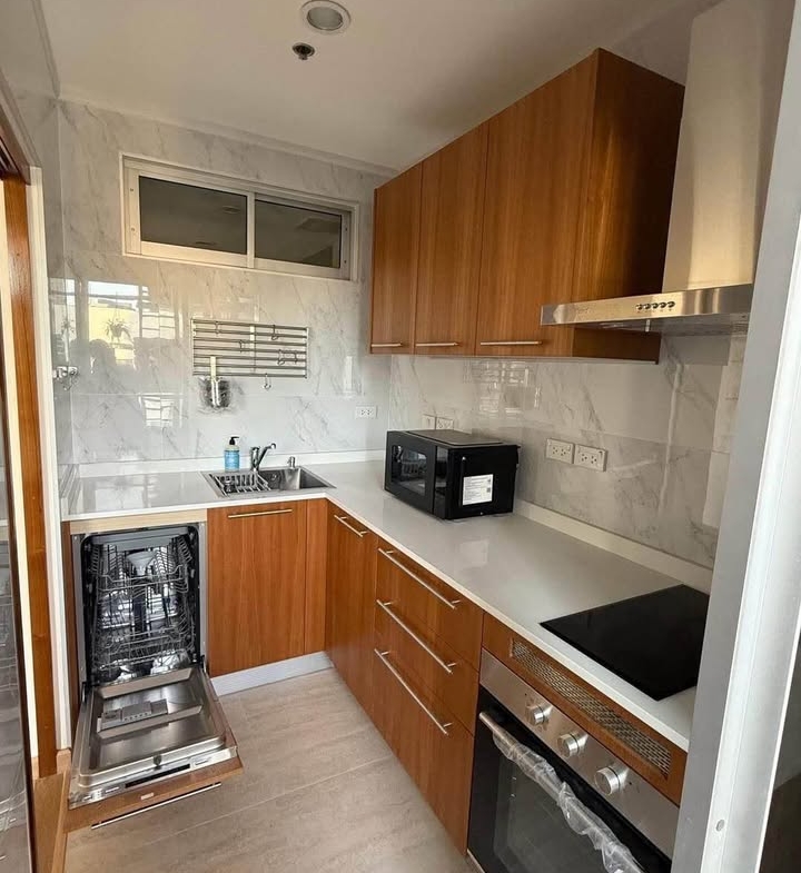 Bright living room of renovated 2-bedroom condo at Condo One X Sukhumvit 26 with city view and modern furnishings
