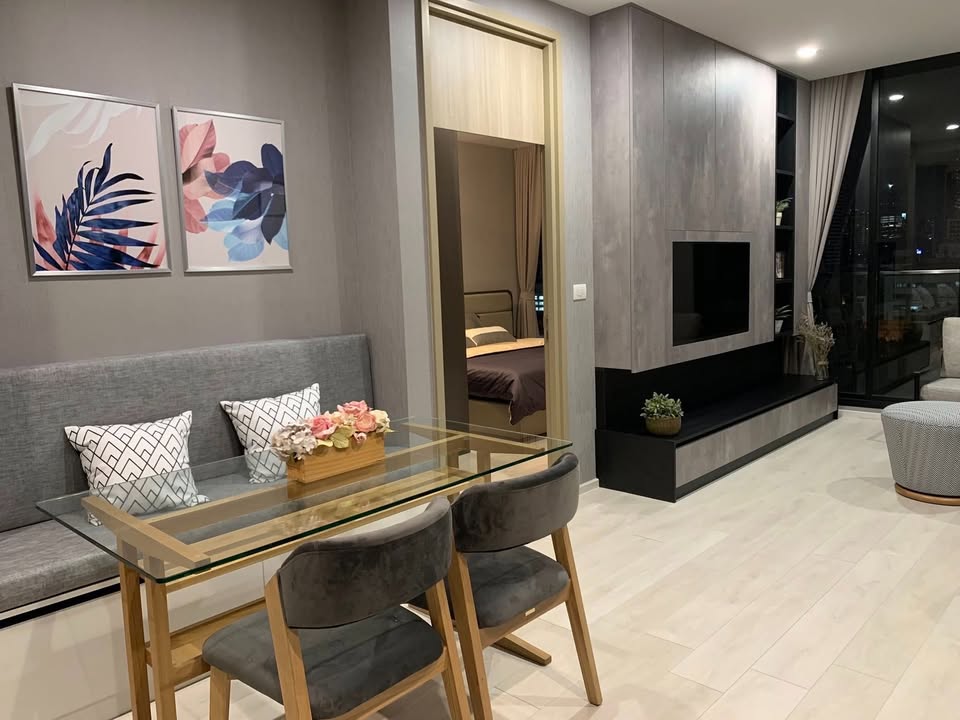 Elegant living room of 2-bedroom condo at Noble Ploenchit with city view and modern furnishings