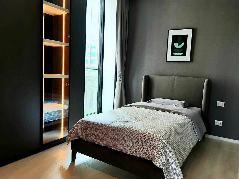 Elegant living room of 2-bedroom condo at Noble Ploenchit with city view and modern furnishings