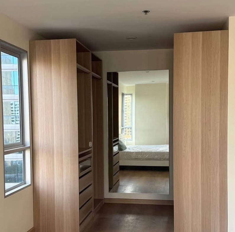 Bright living room of renovated 2-bedroom condo at Condo One X Sukhumvit 26 with city view and modern furnishings