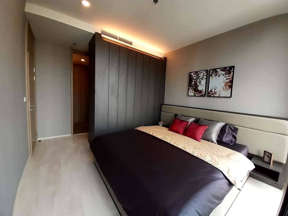 Elegant living room of 2-bedroom condo at Noble Ploenchit with city view and modern furnishings
