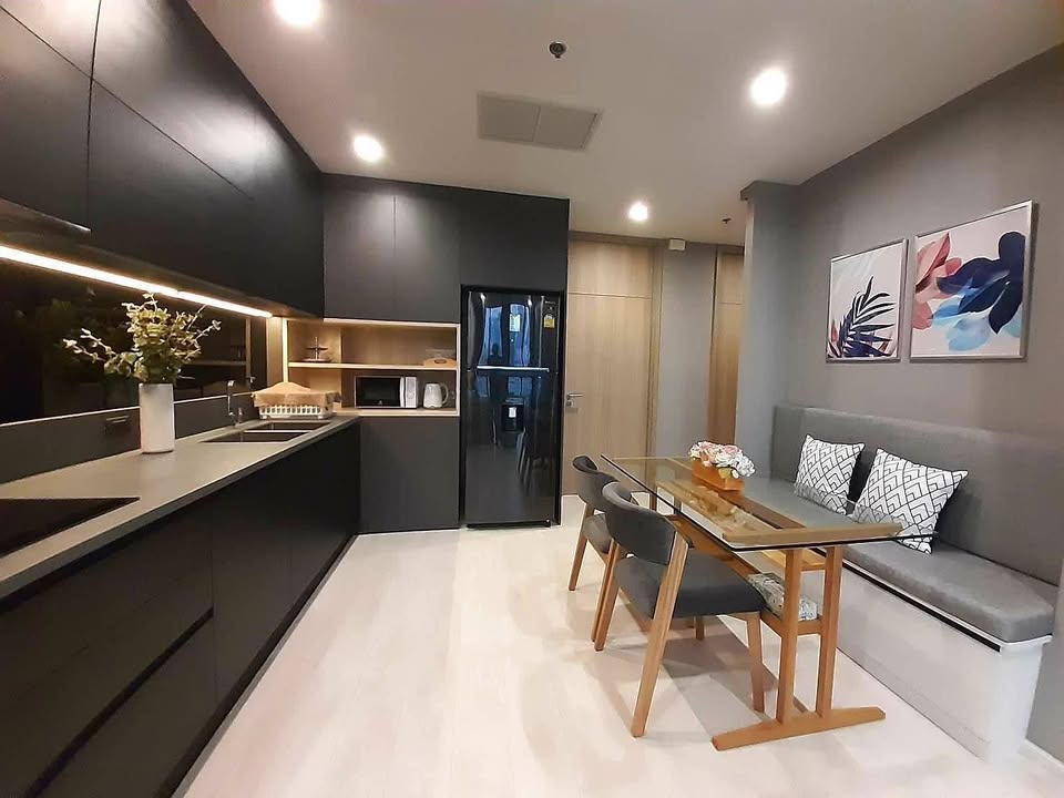 Elegant living room of 2-bedroom condo at Noble Ploenchit with city view and modern furnishings