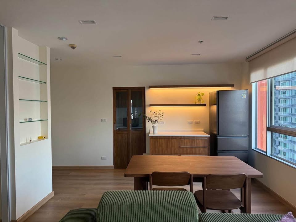 Bright living room of renovated 2-bedroom condo at Condo One X Sukhumvit 26 with city view and modern furnishings