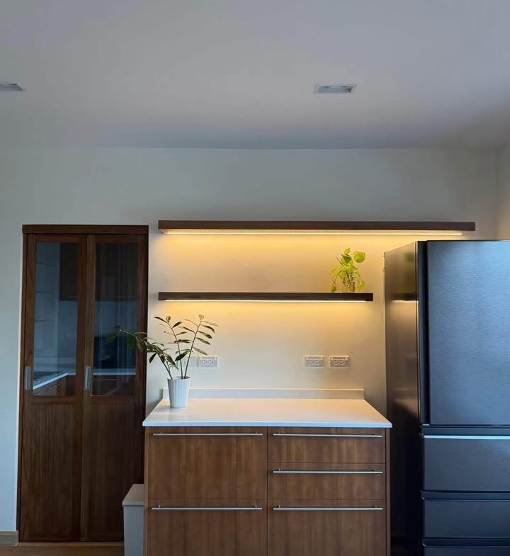 Bright living room of renovated 2-bedroom condo at Condo One X Sukhumvit 26 with city view and modern furnishings
