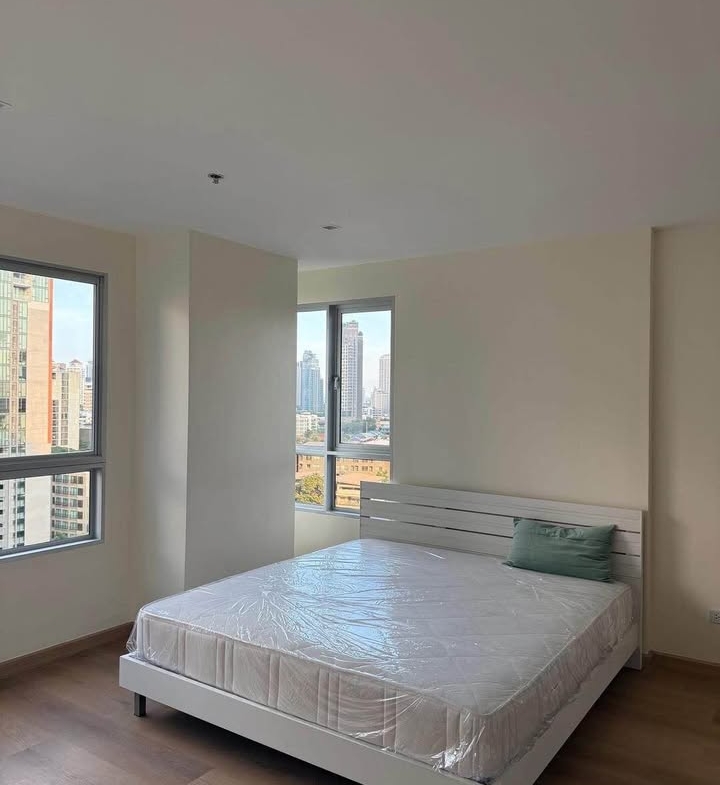 Bright living room of renovated 2-bedroom condo at Condo One X Sukhumvit 26 with city view and modern furnishings